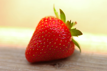 Fresh strawberry photographed in daylight conditions
