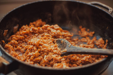 Cooking indian daal or beans in big pan. Hot meal with spices masala