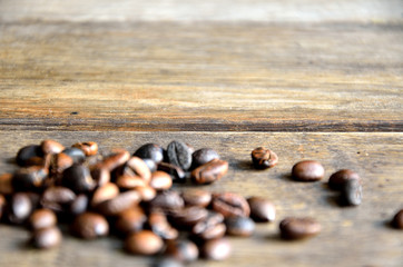 Roasted coffee grains on wooden boards.