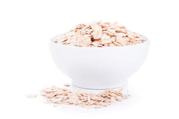 Low carbohydrates. Dry oat flakes in white bowl
