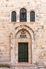 Fototapeta na wymiar Door and Arched Windows in the Exterior of Church of the Holy Sepulchre, Jerusalem Old City Israel 