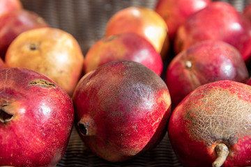 Closeup of Rows of Ripe Yellow and Red Pomegranates in a Market