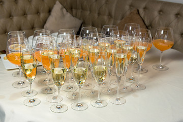many glasses of champagne are on the table. Horizontal frame