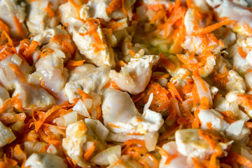 Cooking, sliced carrots and meat fried in a pan