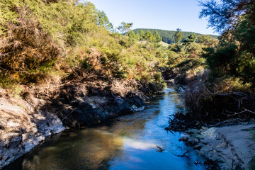 Naklejka na ściany i meble The Waikato river flows through the Geo-Thermal park, Wai-O-Tapu, Rotorua, New Zealand