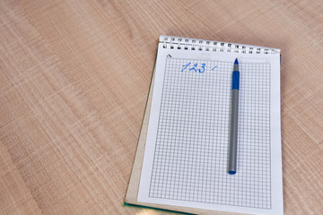 Ballpoint pen in a notebook on a brown background. Office. notebook and ballpoint pen on the table