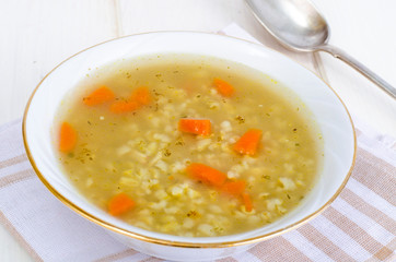Vegetable broth with brown rice and carrots.