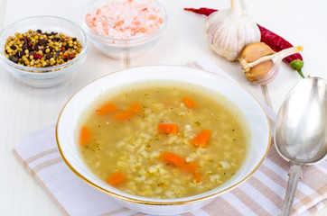 Vegetable broth with brown rice and carrots.