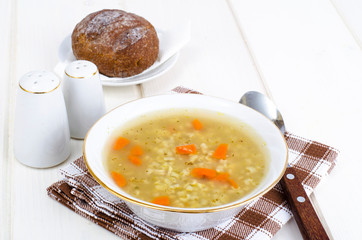 Vegetable broth with brown rice and carrots.