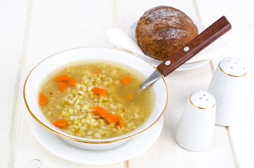 Vegetable broth with brown rice and carrots.
