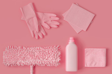Pink cleaning kit in the house on a pink background.