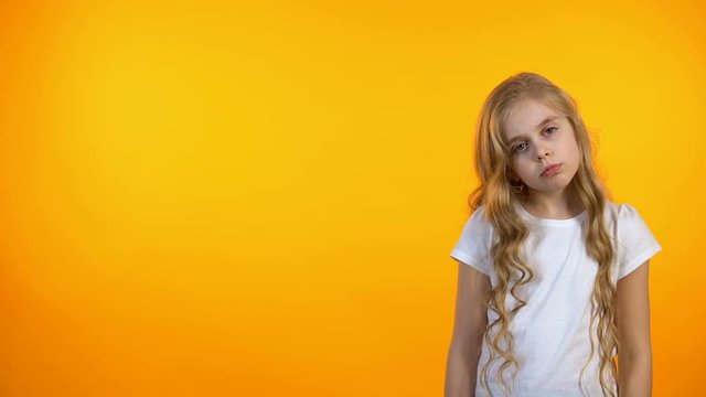 Lovely girl making facepalm gesture, tired after school, unhappy with assignment