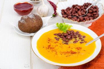 Vegetable vegetarian carrot pumpkin soup cream with red beans