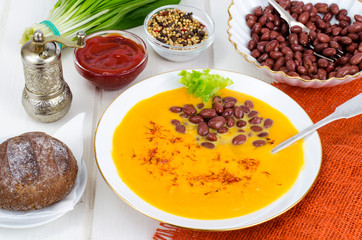 Vegetable vegetarian carrot pumpkin soup cream with red beans