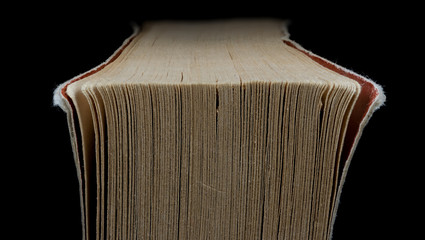 Macro image of worn corner of pages of a book.