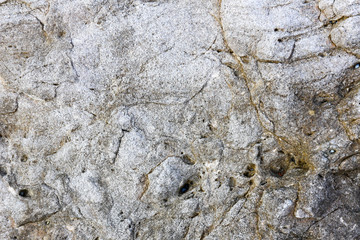 Rock texture and surface background. Cracked and weathered natural stone background.