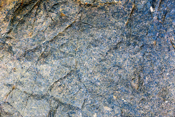 Rock texture and surface background. Cracked and weathered natural stone background.