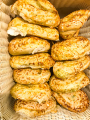 Baskets with buns, bread and cakes in store