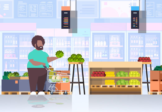 Fat Obese Man With Shopping Trolley Cart Choosing Vegetables And Fruits Overweight African American Guy Supermarket Customer Weight Loss Concept Grocery Shop Interior Horizontal Full Length