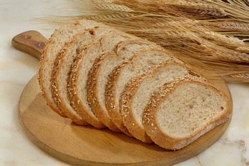 Bread,Plenty of sliced bread background, Bakery and grocery concept. Fresh, healthy sorts of rye and white loaves, sprinkled flour on sackcloth and rustic wood table, food closeup.