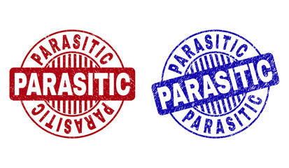 Grunge PARASITIC round stamp seals isolated on a white background. Round seals with grunge texture in red and blue colors. Vector rubber watermark of PARASITIC label inside circle form with stripes.