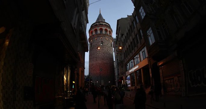 ISTANBUL, TURKEY- JANUARY 17, 2018 : place Galata tower is medieval stone tower in Karakoy squere Istanbul Turkey. Tourists visiting Galata Tower at night. Time Lapse