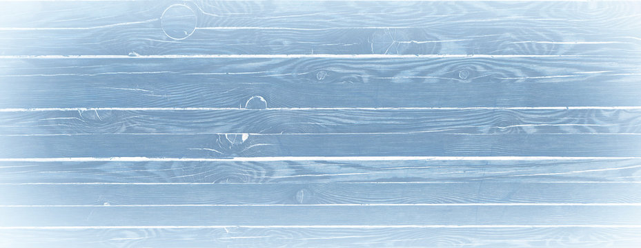 Light blue wood textured background. Wooden planks on a wall or floor with grain and texture.
