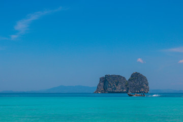 Boat floating on ocean island in Thailand
