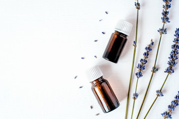 Dried lavender with a bottle of essential oil isolated on white background.