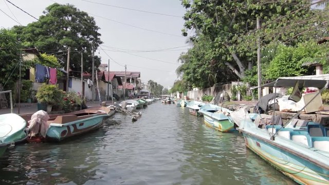 Boat driving on indian city river channel with colorful boats