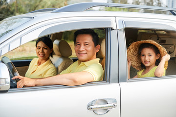 Cheerful family riding in car