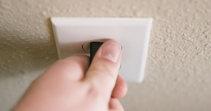 Close Up of Man's Hand Plugging Cord Into Electrical Outlet Then Unplugging in Slow Motion
