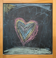 heart and sun, kids chalk drawing on blackboard