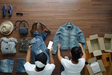 Selling online ideas concept small business owner, Top view men using smart phone and women working...