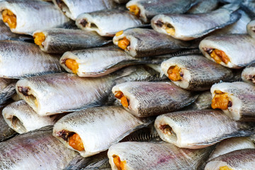 pattern of dried salted damselfish on threshing bamboo basket, its favorite food