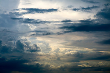 storm silhouette heap cloud sun ray in gray sky dark cloud
