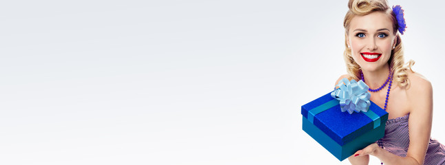 woman in pin-up style clothing with gift box