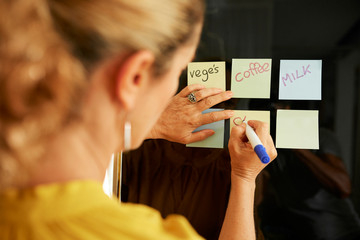 Woman writing shopping list