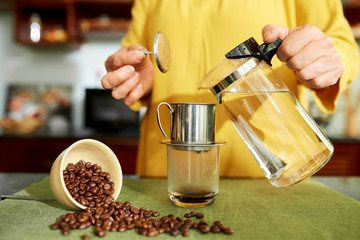 Woman poring hot water in pot