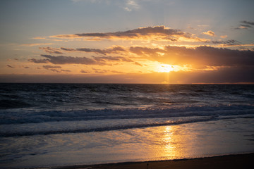 Colorful beach sunrise with a vibrant sky line 