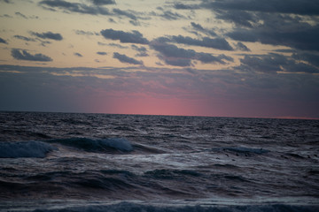 Colorful beach sunrise with a vibrant sky line 