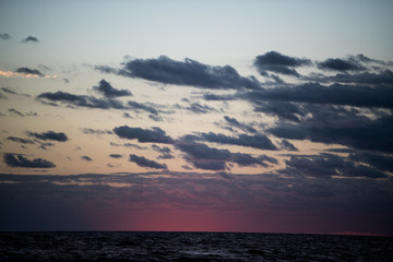 Colorful beach sunrise with a vibrant sky line 