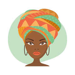 Portrait of a beautiful African woman in traditional turban. African girl. Headdress of Africa, african beauty