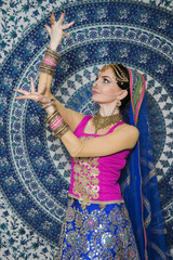 Portrait of a female model in ethnic indian costume with  jewellery and traditional makeup.