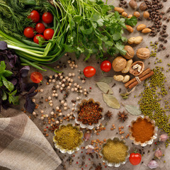 Fresh greens and tomatoes cereals spices and nuts organic healthy snacks on a textural background. The concept of healthy eating. Lean foods.
