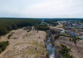 Fototapeta na wymiar Aerial shot of Gileva village, river, field and forest. Sunny, spring