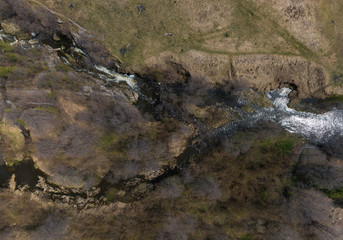 Aerial shot of Gileva village, river and small waterfall. Sunny, spring