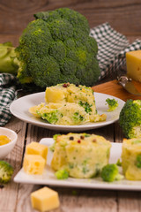 Potato gratins with broccoli florets.