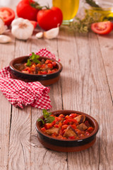 Marinated pork loin in tomato sauce.