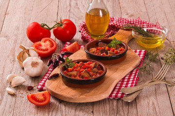 Marinated pork loin in tomato sauce.